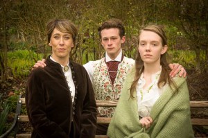 Woman, young man and girl together, all well dressed