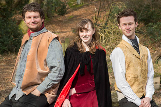 Two young men and a young woman together, smiling
