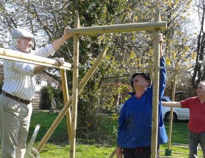 Three men building wooden frames
