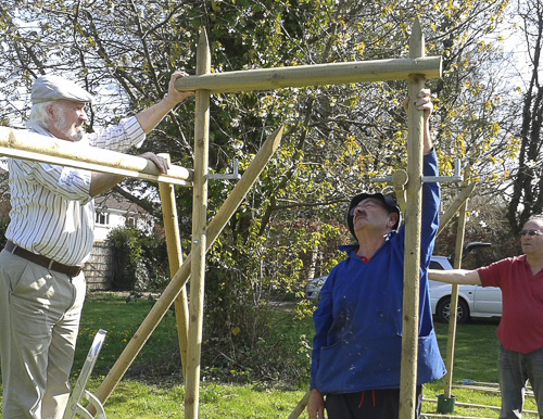 Three men building wooden frames