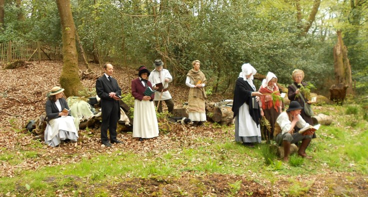 Group of people in nineteenth century costume, in a clearing