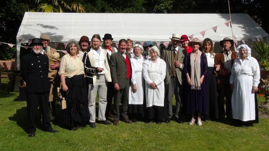 Group photo taken in front of a marquee